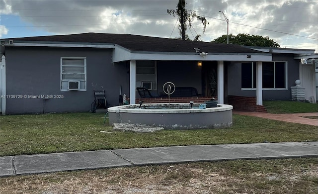 exterior space with cooling unit and a front lawn