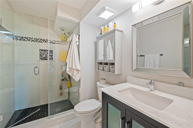 bathroom featuring an enclosed shower, vanity, and toilet