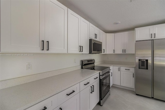 kitchen featuring white cabinetry, appliances with stainless steel finishes, and a textured ceiling