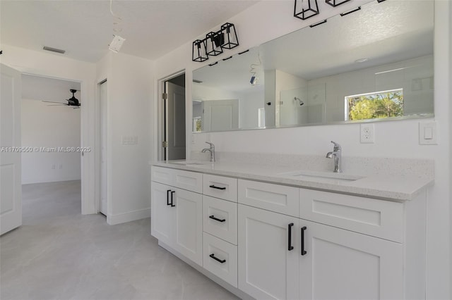 bathroom featuring double vanity, visible vents, a stall shower, and a sink