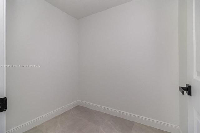 spare room with baseboards