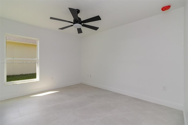 unfurnished room with baseboards and ceiling fan