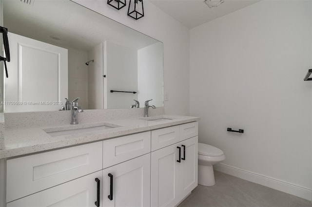 full bathroom featuring tile patterned flooring, double vanity, toilet, and a sink