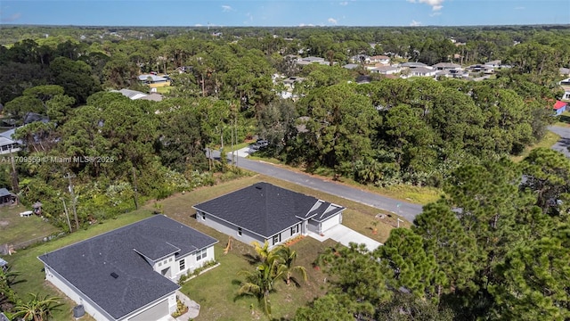 drone / aerial view featuring a view of trees