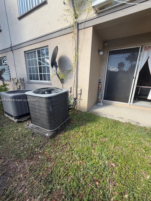 1967 Marsh Harbor Dr Unit 313, Riviera Beach, FL 33404 - exterior view of a central AC unit and stucco siding