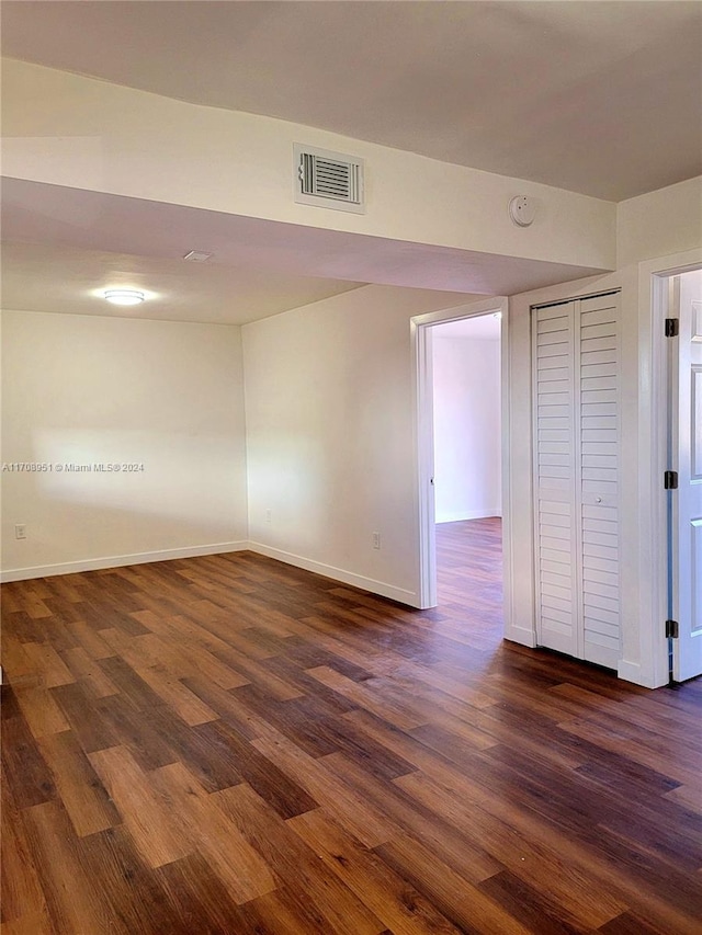 spare room with dark hardwood / wood-style flooring