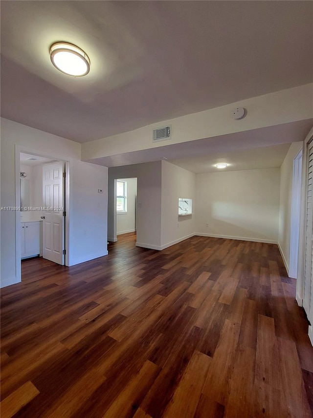 empty room with dark hardwood / wood-style floors