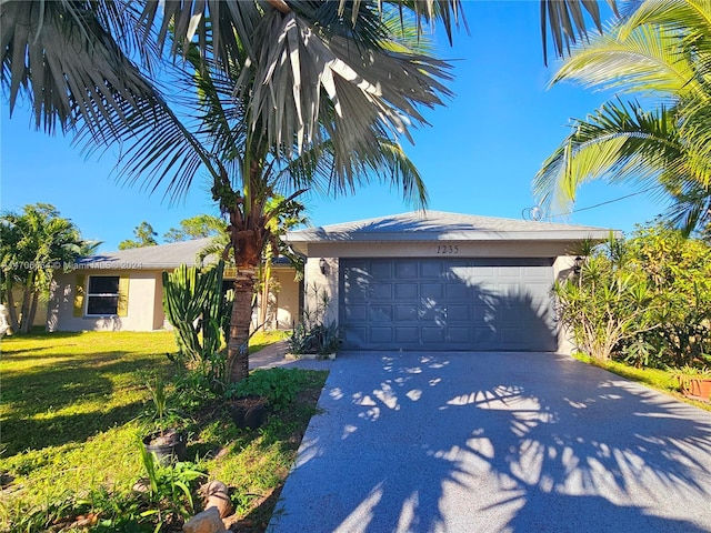 view of front facade with a garage and a front yard