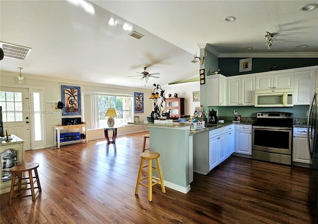 kitchen featuring kitchen peninsula, vaulted ceiling, crown molding, white cabinetry, and stainless steel electric range