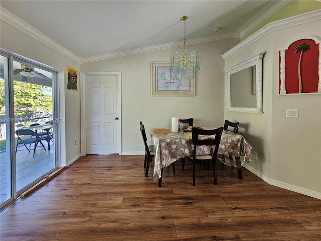 dining area featuring dark hardwood / wood-style floors, lofted ceiling, ornamental molding, and an inviting chandelier