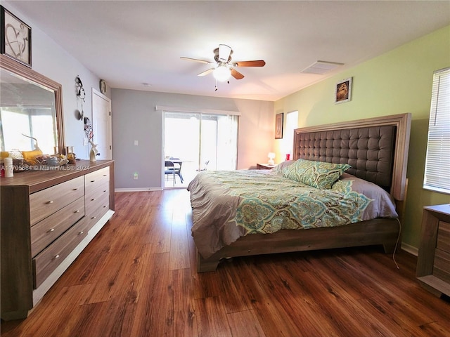 bedroom featuring access to outside, ceiling fan, and dark hardwood / wood-style floors