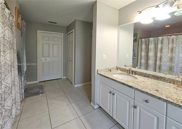 bathroom featuring tile patterned flooring and vanity