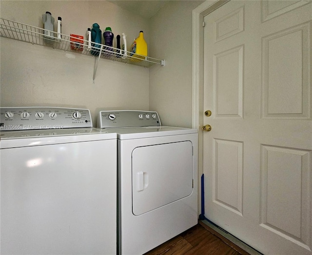 clothes washing area with washing machine and dryer and dark wood-type flooring