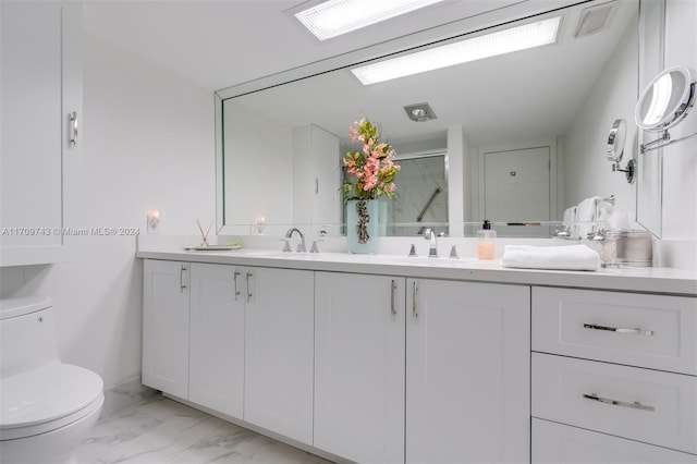 bathroom with walk in shower, vanity, and toilet