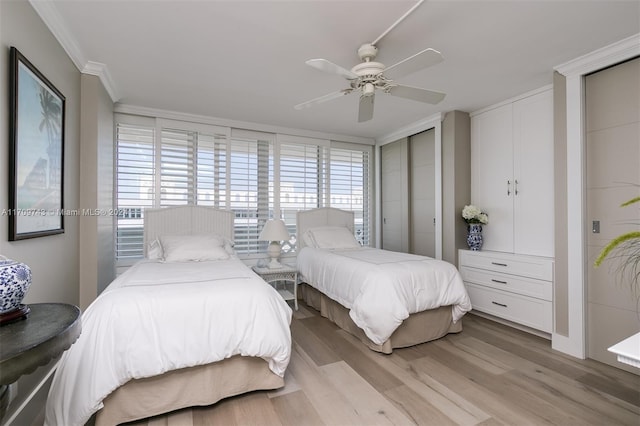 bedroom featuring ceiling fan, light hardwood / wood-style floors, and ornamental molding