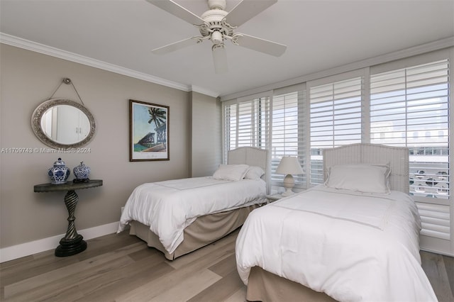 bedroom with hardwood / wood-style flooring, ceiling fan, and crown molding