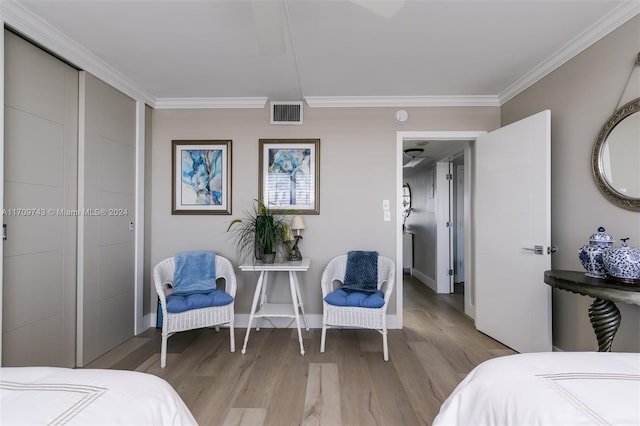 bedroom with crown molding and light hardwood / wood-style flooring