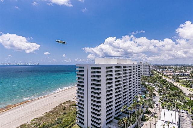 exterior space with a water view and a view of the beach