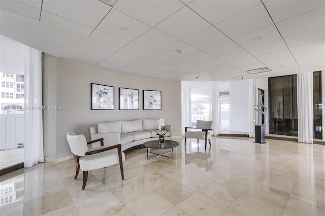 living room with a drop ceiling