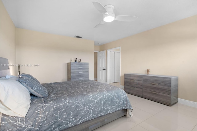 bedroom with a closet, ceiling fan, and light tile patterned flooring