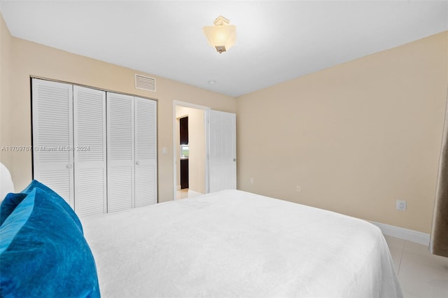 bedroom featuring a closet and light tile patterned floors