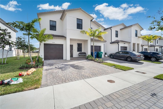 view of front of house featuring a front yard and a garage