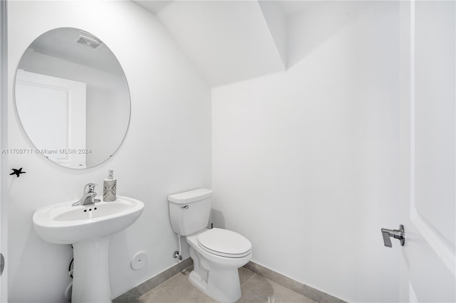 bathroom with toilet and tile patterned floors