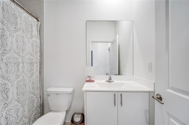 bathroom featuring vanity, curtained shower, and toilet