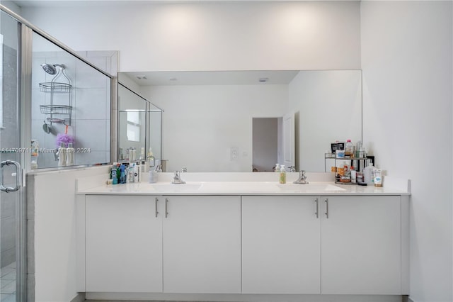 bathroom featuring vanity and a shower with shower door