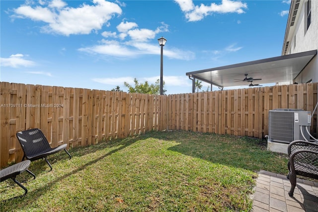 view of yard featuring ceiling fan and cooling unit