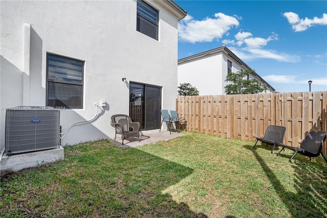 view of yard with cooling unit and a patio area