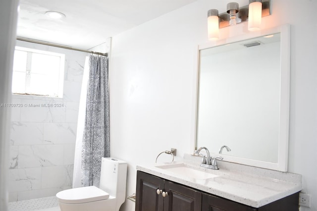 bathroom featuring vanity, toilet, and curtained shower