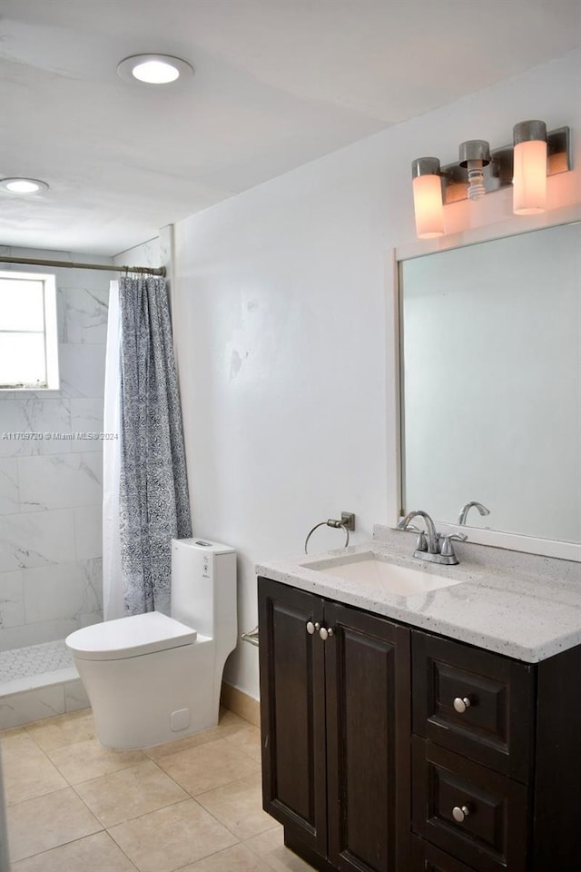 bathroom with tile patterned flooring, vanity, toilet, and curtained shower