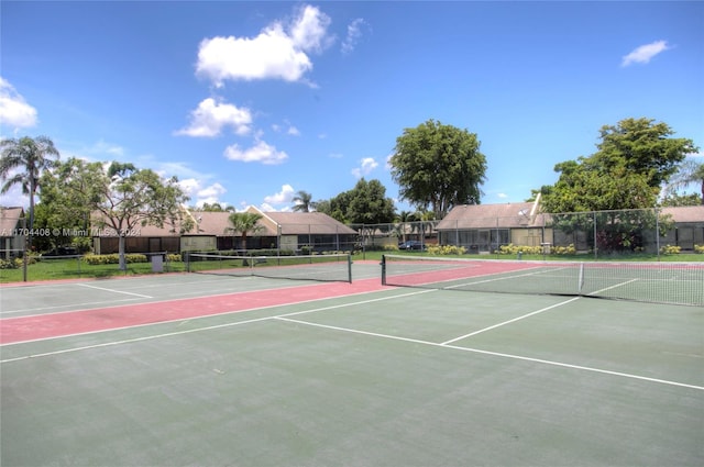 view of tennis court featuring basketball hoop