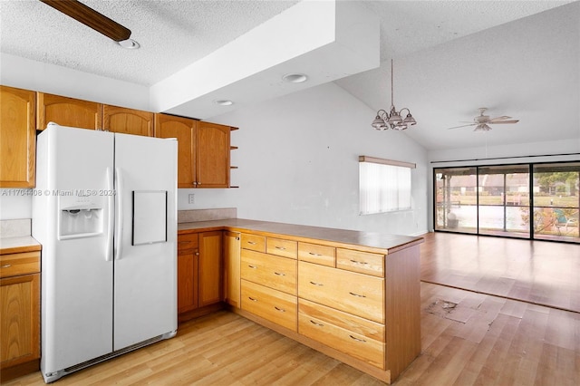 kitchen featuring white fridge with ice dispenser, light hardwood / wood-style flooring, kitchen peninsula, decorative light fixtures, and lofted ceiling