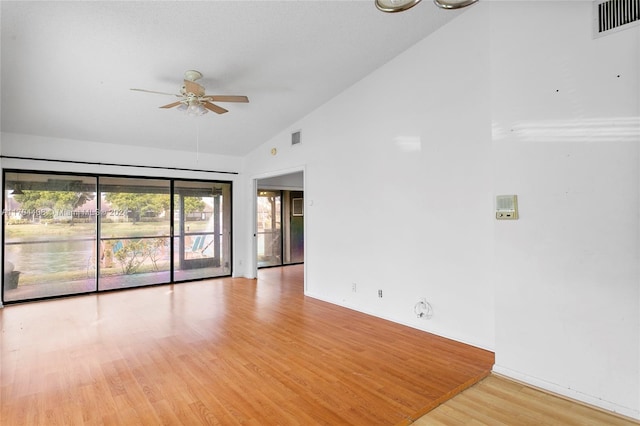 spare room with high vaulted ceiling, light hardwood / wood-style flooring, and ceiling fan