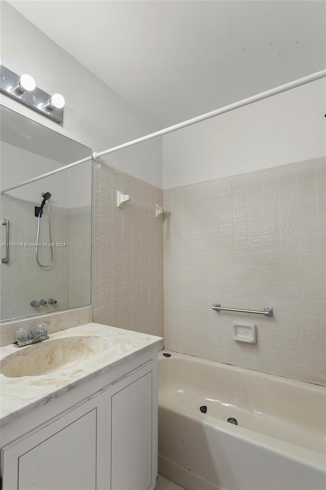 bathroom featuring vanity and tiled shower / bath