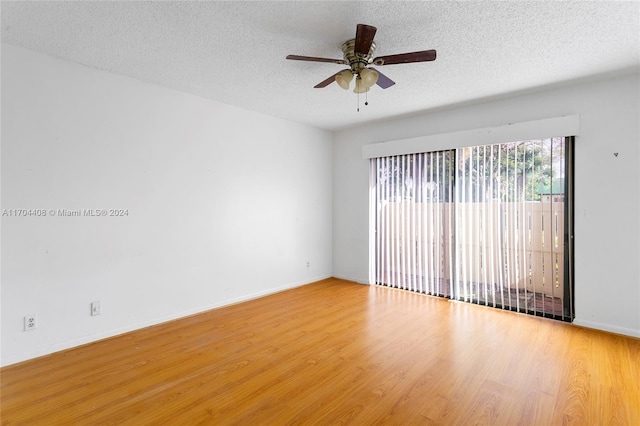 spare room featuring ceiling fan, hardwood / wood-style floors, and a textured ceiling