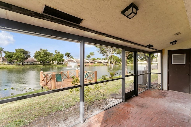 unfurnished sunroom with a water view and lofted ceiling