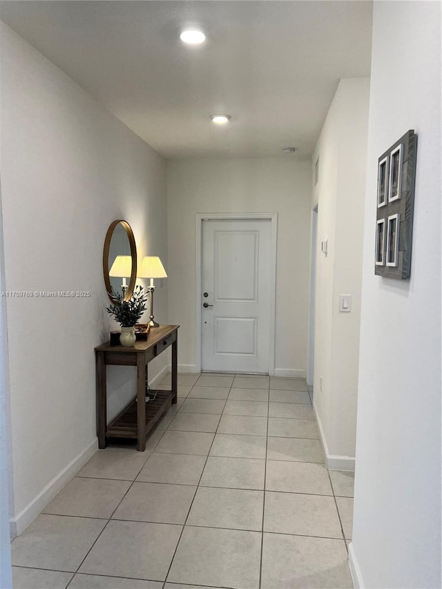 hall featuring light tile patterned flooring