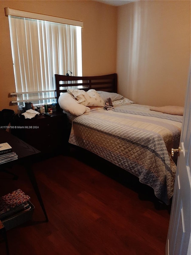 bedroom with hardwood / wood-style floors