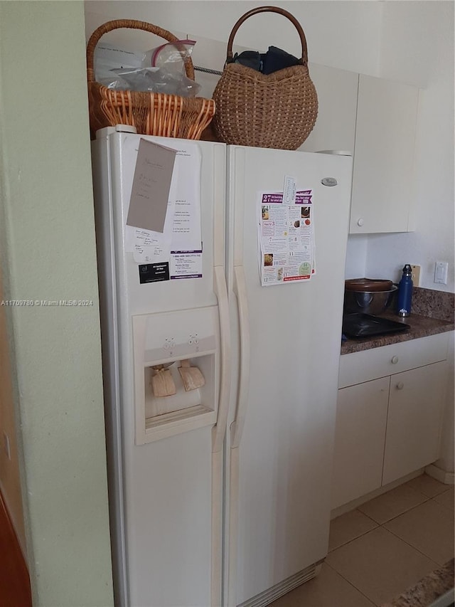 room details featuring white cabinets and white fridge with ice dispenser