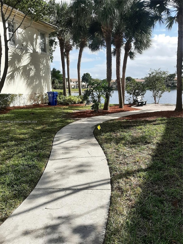 view of community featuring a yard and a water view