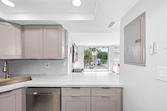 kitchen with light stone countertops, sink, stainless steel dishwasher, electric panel, and gray cabinets