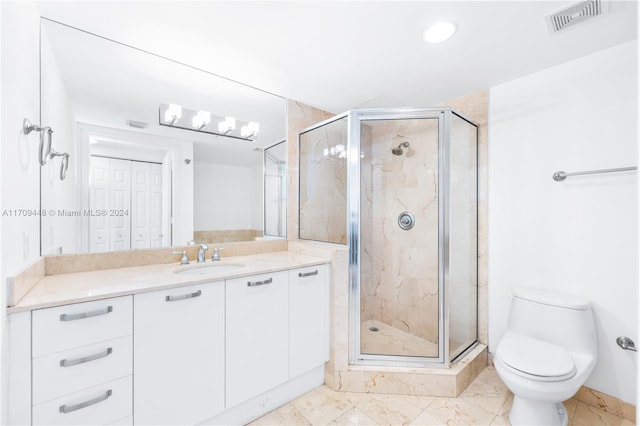 bathroom featuring a shower with door, vanity, and toilet