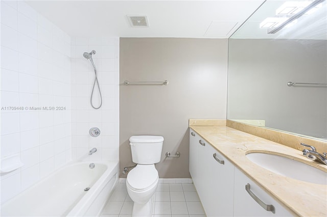 full bathroom with tile patterned flooring, vanity, toilet, and tiled shower / bath