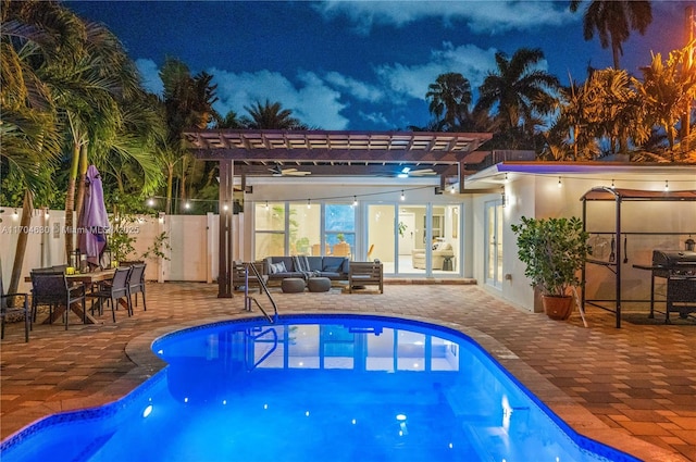 pool at twilight with an outdoor living space, a pergola, area for grilling, and a patio area