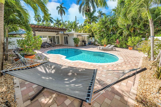 view of swimming pool with a pergola and a patio