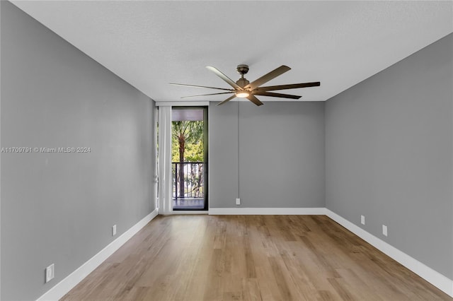 empty room featuring a textured ceiling, light hardwood / wood-style floors, and ceiling fan