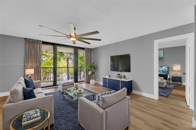 living room with hardwood / wood-style floors and ceiling fan